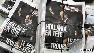 Piles of the French daily newspaper Liberation after early results in the first round vote of the 2012 French presidential election