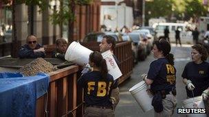 FBI officials remove rubble from the basement 20 April 2012