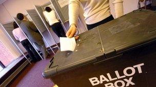 Vote being placed in a ballot box