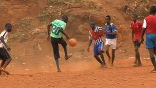 Boys playing football on the patch of land that once housed the amputee camp in Freetown, April 2012