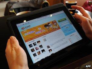 Woman looks at Chinese social media website