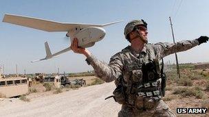 Army 1st Lt. Steven Rose launches an RQ-11 Raven unmanned aerial vehicle near a new highway bridge project along the Euphrates River north of Taqqadum, Iraq, Oct. 9, 2009