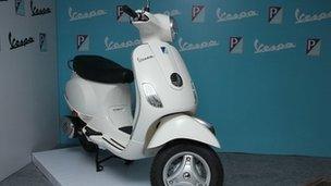 A white Piaggio Vespa LX125