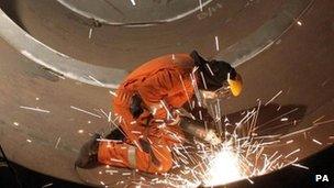 Worker using a grinder