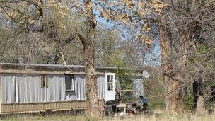 A woman outside her home on Pine Ridge Indian Reservation, South Dakota 23 April 2012