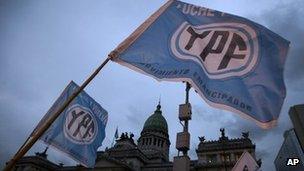 Supporters of an oil nationalization bill proposed by Argentina's President Cristina Fernandez holds up flags reading in Spanish "Fight and return YPF" outside Congress