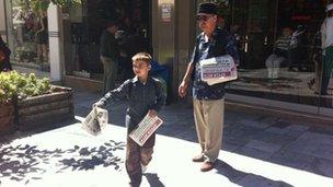 Golden Dawn party members handing out the party newspaper