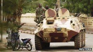 Malian military junta troops who carried out a coup in March guard a street after renewed fighting in the capital Bamako May 1, 2012.