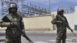 Military police stand guard outside TDE in Cochabamba