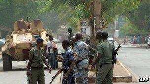 Malian soldiers stand guard at the Patrice Lumouda roundabout, 500m from Mali"s radio station ORTM, in Bamako on May 2, 2012