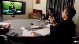 Nicolas Sarkozy (right) speaks to Barack Obama by video link, 12 April 2012