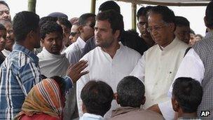 Congress party leader Rahul Gandhi, center, and Assam state Chief Minister Tarun Gogoi, second right, interact with a crowd near the site of a ferry that capsized in the Brahmaputra River, at Buraburi village, about 350 kilometers (215 miles) west of the state capital Gauhati, India, Wednesday, May 2, 2012.