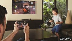 Family playing video game on its television through wireless connectivity