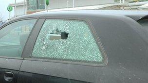 car with bullet hole in window