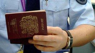 Immigration officer checking a passport