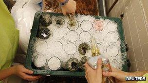 Staff prepare mint juleps before the 138th running of the Kentucky Derby