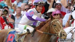 Mario Gutierrez celebrates atop I'll Have Another after winning the 138th running of the Kentucky Derby