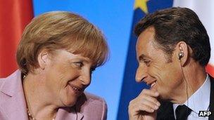 French President Nicolas Sarkozy looks at German Chancellor Angela Merkel at a press conference in 2008