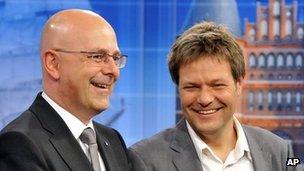 SPD top candidate Torsten Albig, left, and Robert Habeck of the Greens react after the first results of the German state election of Schleswig-Holstein