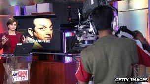 Cameraman films presenter in studio