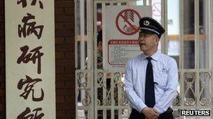 A security guard outside the hospital where activist Chen Guangcheng is being treated