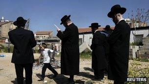 Ultra-Orthodox Jewish men pray as they burn leaven in the Mea Shearim neighbourhood of Jerusalem, ahead of the Jewish holiday of Passover, April 6, 2012.