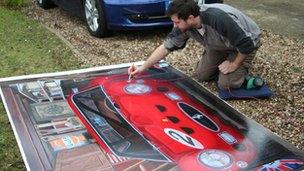 Chris Smart painting the garage cover