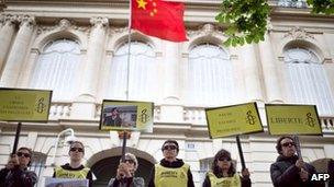 Amnesty International activists take part in a protest in support of Chen Guangcheng, on 9 May, 2012 in front of China's embassy in Paris