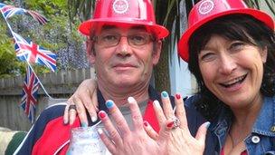 A man and woman show their painted nails at a street party in Cardiff