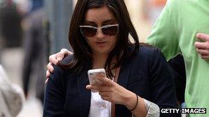 A woman uses a smartphone