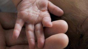 Newborn baby and hands