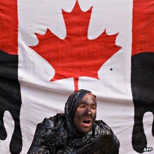 Environmental protester with Canadian flag