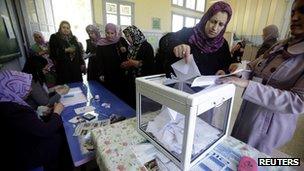 A woman casts her ballot during parliamentary elections at a polling station in the Berber region of Issers, east of Algiers, May 10, 2012