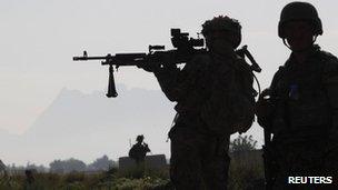 A U.S. soldier from 3rd platoon Bronco troop 5-20 infantry Regiment, attached to 82nd Airborne looks through his sights while on patrol with Afghan national Army soldiers in Zharay district, Kandahar province,