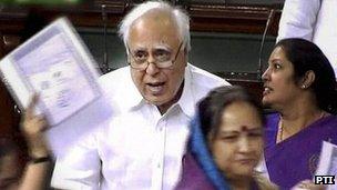 MPs wave copies of the cartoon as Education Minister Kapil Sibal speaks in parliament on 11 May 2012