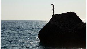 Man on steep rock