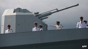 Chinese navy servicemen onboard the Chinese missile frigate Yuncheng (571) in Hong Kong on 30 April 30 2012