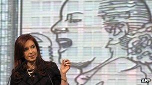 Argentine President Fernandez in front of a mural of Evita