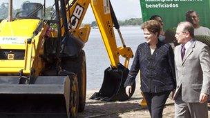 President Dilma Rousseff and the governor of Rio Grande do Sul state, Tarso Genro walking by a backhoe loader