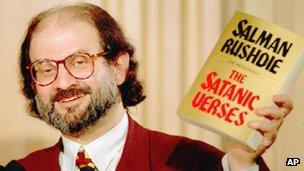 Salman Rushdie holds up a copy of the Satanic Verses in 1992