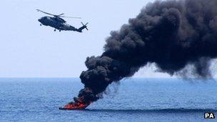 Undated handout photo issued by the Ministry of Defence of HMS Westminster"s Merlin 502 firing at the pirate skiff, fire starting on impact, as the ship disrupted piracy in the Indian Ocean during her 7 month deployment to the region.