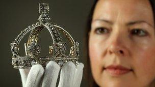 Caroline de Guitaut, Curator of Royal Collections, holds Queen Victoria's small diamond crown from 1870 at The Queen's Gallery, Buckingham Palace