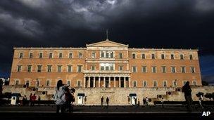 People walk outside the Greek parliament on Tuesday, 15 May 2012