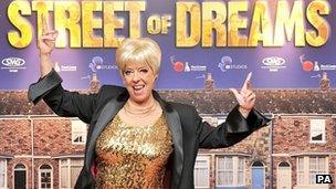 Julie Goodyear in front of Street of Dreams poster