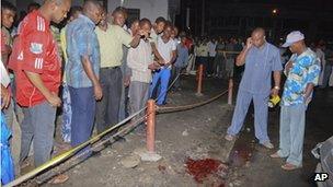 People gather at the site of an explosion outside the Bella Vista nightclub in Mombasa, Kenya, late on Tuesday