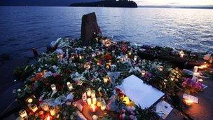 Flowers and candles on the shore opposite Utoeya island, July 2011