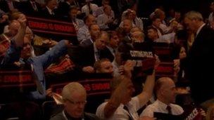 Officers hold up placards at Police Federation conference