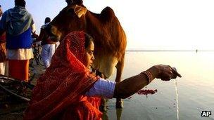 A Hindu prays on the banks of Sangam, the confluence of river Ganges