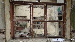 This image provided by the Local Coordination Committees activist network shows alleged damage to a building in Homs after shelling