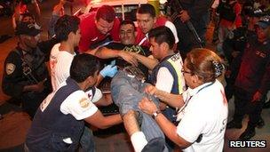 Inmate being carried out of a jail in San Pedro Sula